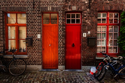 Doors of old houses and bicycles in european city. Bruges (Brugge), Belgium
