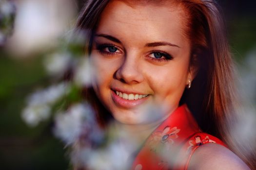 Beautiful girl in a red dress in the colors of cherry