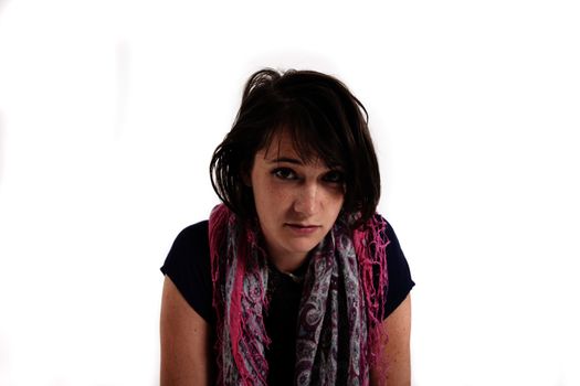 variation of expression on the face of a young brunette woman in studio with a colored scarf