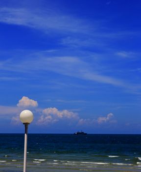 Coast of beach with fishing boat and lamp