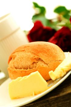 Bread butter and roses on wooden table - romantic breakfast  composition