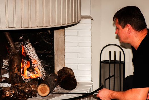 Men setting fire in fireplace