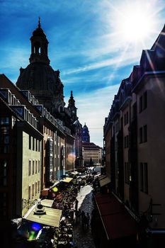 Narrow street in Dresden with shopping people and restaurants
