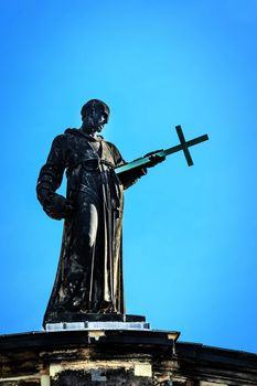 Sacred statue on the top of the cathedral "Hofkirche" in Dresden, Germany