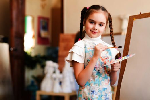 portrait of a girl standing next to his easel, a drawing lesson