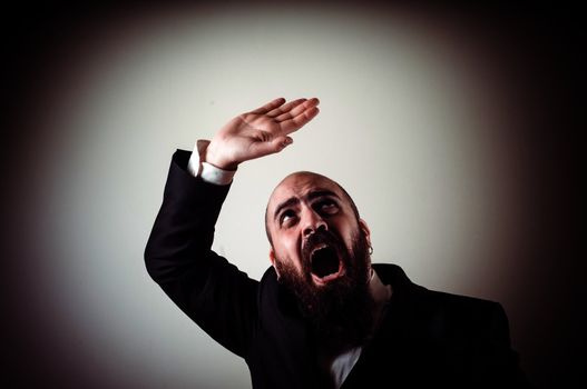 funny afraid elegant bearded man on vignetting background