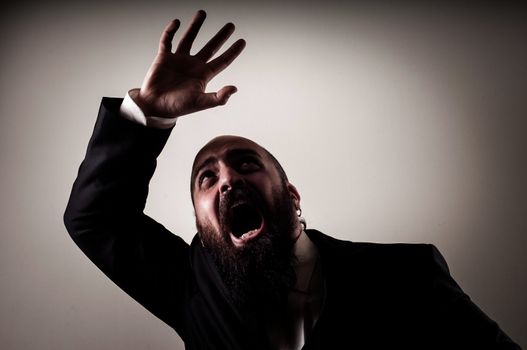 funny afraid elegant bearded man on vignetting background