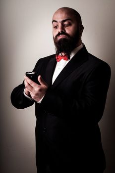  funny elegant bearded man on the phone on vignetting background