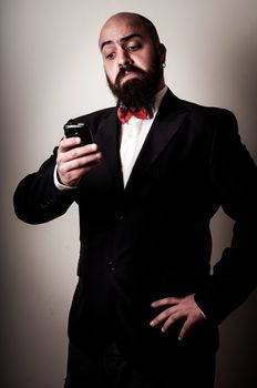  funny elegant bearded man on the phone on vignetting background