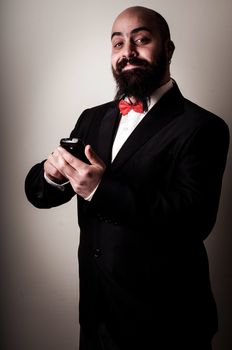  funny elegant bearded man on the phone on vignetting background