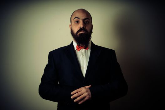  funny elegant bearded man on vignetting background