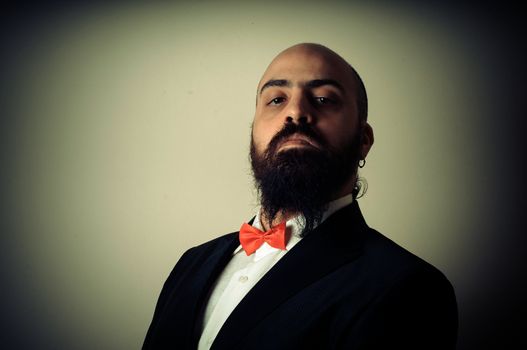 funny elegant bearded man on vignetting background