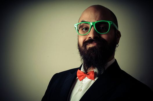  funny elegant bearded man on vignetting background