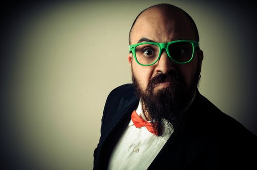  funny elegant bearded man on vignetting background