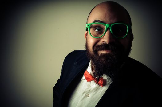  funny elegant bearded man on vignetting background