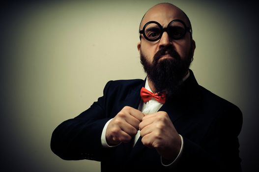  funny elegant bearded man on vignetting background