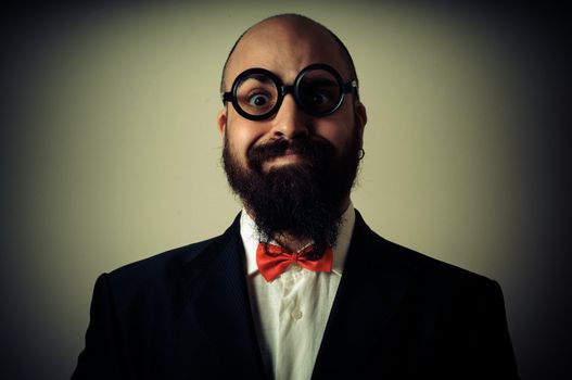  funny elegant bearded man on vignetting background