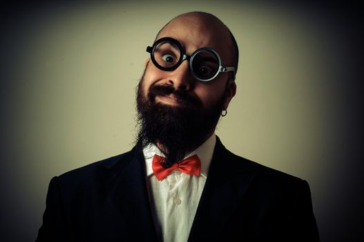  funny elegant bearded man on vignetting background