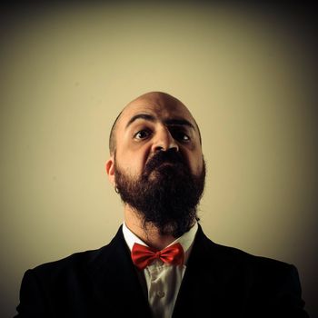  funny elegant bearded man on vignetting background