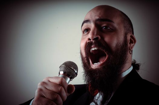  funny elegant singer bearded on vignetting background
