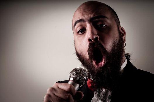  funny elegant singer bearded on vignetting background