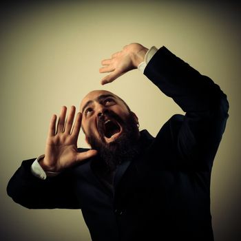 funny afraid elegant bearded man on vignetting background