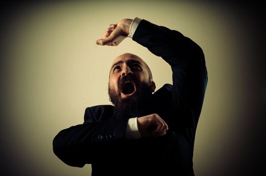 funny afraid elegant bearded man on vignetting background