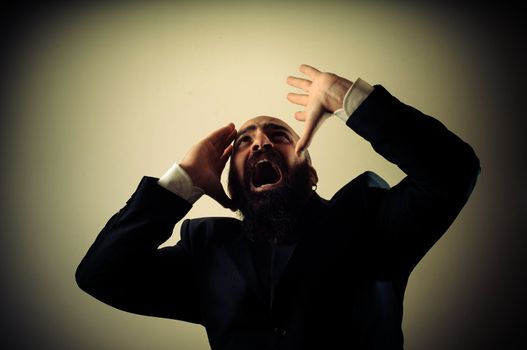 funny afraid elegant bearded man on vignetting background