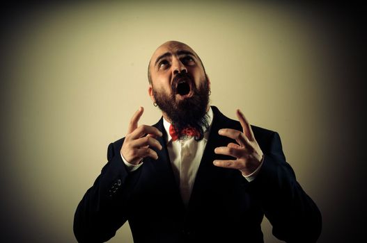 funny afraid elegant bearded man on vignetting background