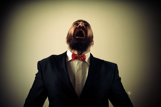 funny afraid elegant bearded man on vignetting background