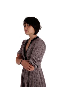 portrait of a young woman in grey dress arms crossed on studio