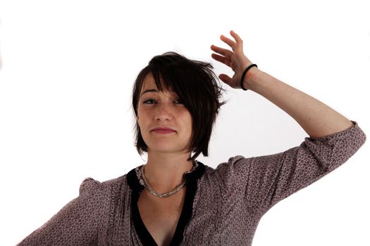 portrait of a young woman in grey dress playing with her hair on studio