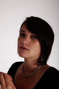 variation of expression on the face of a young brunette woman in studio with a colored scarf