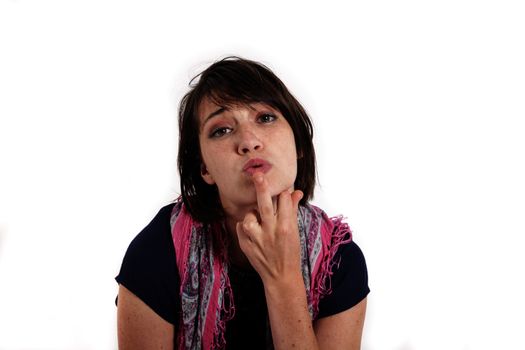 humorous portrait of a young brunette woman with finger of her mouth, colored scarf