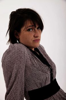 young brunette woman in dress sitting on the ground with boots