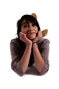 young brunette woman lenthened on the ground isolated in studio looking ahead