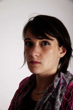 portrait of a young brunette woman with colored scarf looking ahead