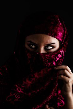 Arab women with traditional red veil, eyes intense, mystical beauty