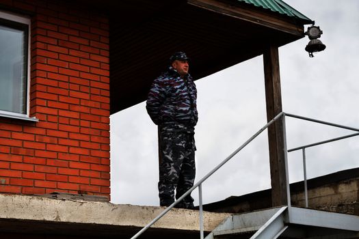 A security guard in camouflage at the post