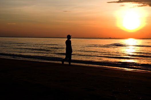 silhouette woman walking on the beach