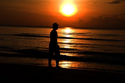 silhouette woman walking on the beach