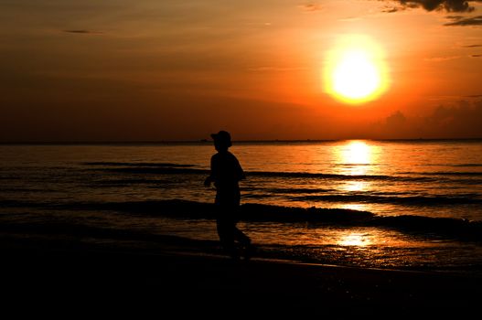 silhouette woman running on the beach