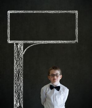 Thinking boy dressed up as business man with chalk road advertising sign on blackboard background