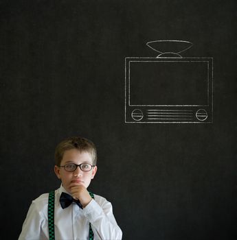 Thinking boy dressed up as business man with chalk tv television on blackboard background