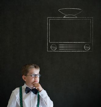 Thinking boy dressed up as business man with chalk tv television on blackboard background