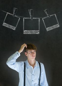 Businessman, teacher or student with chalk instant photograph style photographs on clothes line blackboard background