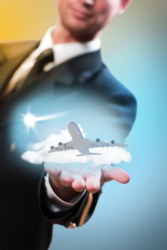 pilot in the form of extending a hand to a flying airplane with sky, clouds and sun