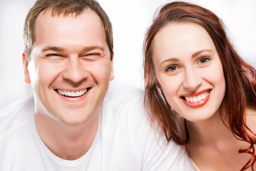 closeup portrait of a couple, smiling and looking into the camera