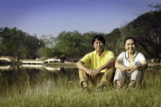 Happy couple Posing for A Portrait in the Park by the Lake. 