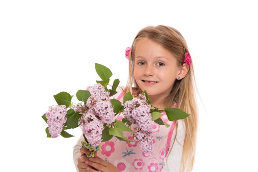 Happy little girl with long hair wearing summer dress and holding lilac flowers. Isolated on white background.